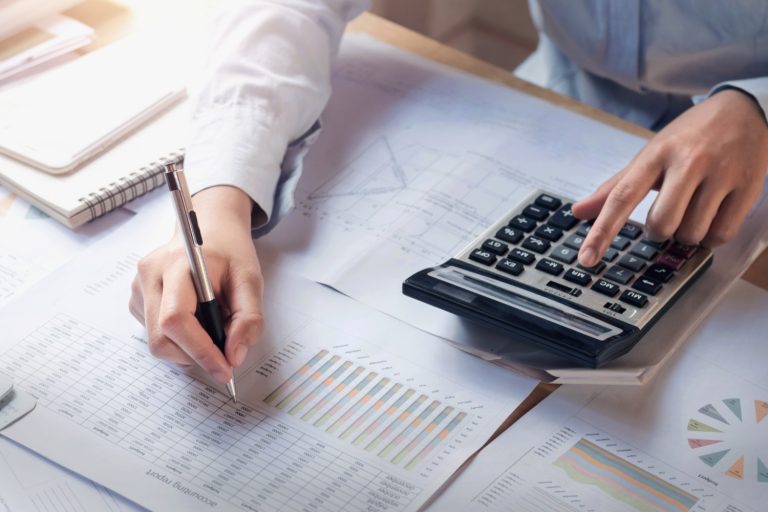finance accounting concept business woman working desk using calculator