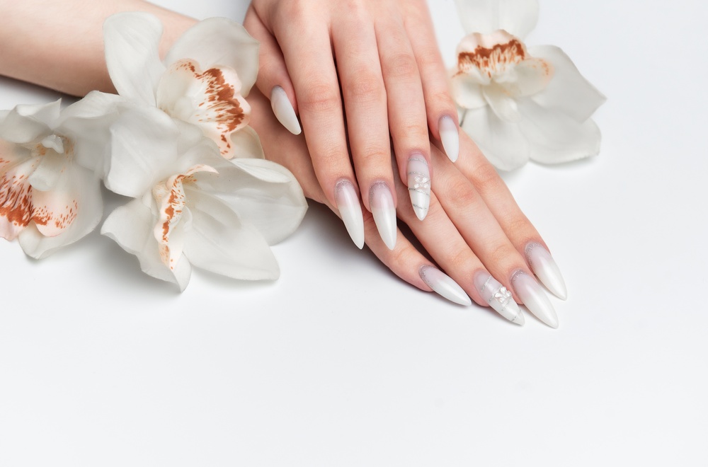 female,hands,with,white,long,almond,nails,and,nail,art